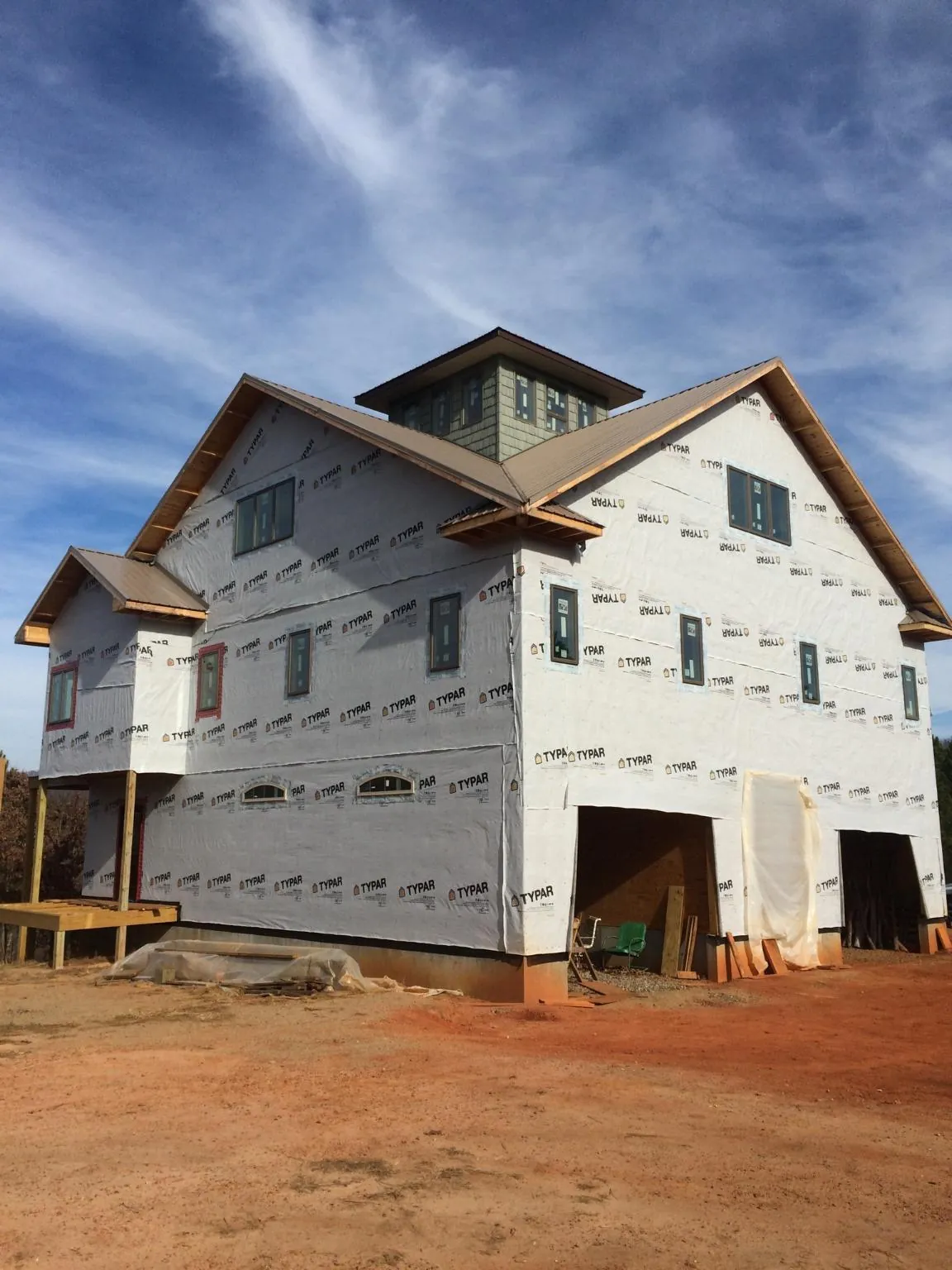 New two story house under construction with a cupola and gabled roofs in University Place
